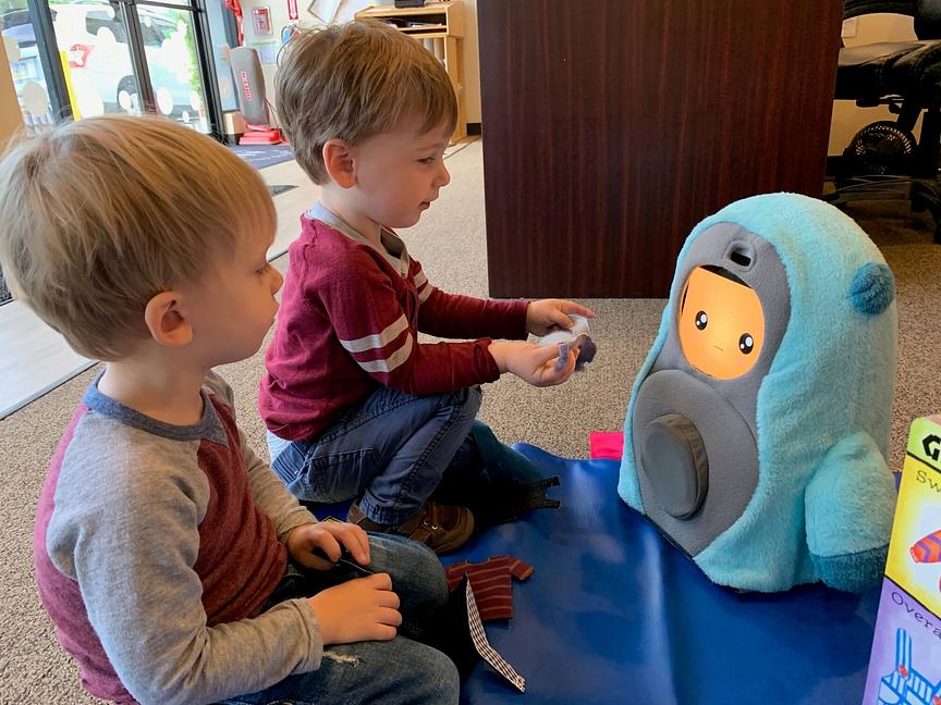 Children engaging with the Peerbots robot